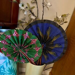 TWO AFRICAN FABRIC AND LEATHER FANS